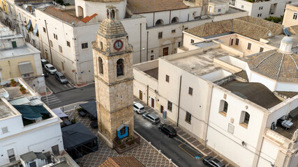 Fototapeta premium Aerial view of the Orsini bell tower located in the historic center of Manfredonia, in the province of Foggia, Puglia, Italy.