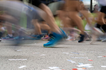 Closeup long exposure many persons and legs running marathon race stock photo with space for text non recognizable people on it