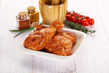 Raw turkey shoulder wing in Indian tandoori marinade