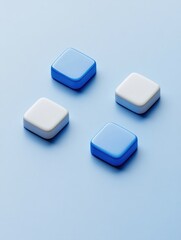 Three colorful button-like objects, each with a unique hue - blue, white, and grey, presented on a clean, solid background.