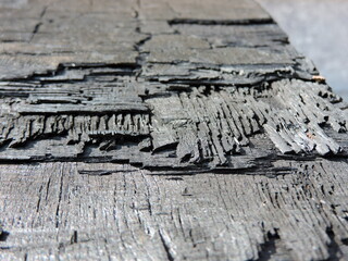 a piece of burnt wood looks like a ramp or stairs of black stone