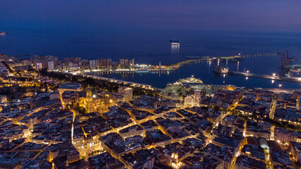 Aerial Magic of Malaga: Illuminated City and Harbor at Night.  travel, urban photography, architecture, and coastal lifestyle concepts.Malaga Spain