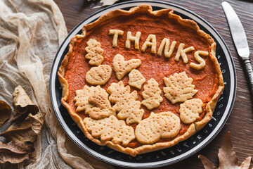 preparation process of Thanksgiving Pumpkin pie with autumn leaves decor