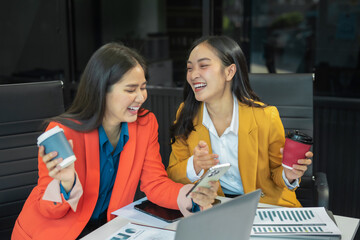 female colleague of half Asian descent holds a cup of coffee and smiles happily.
