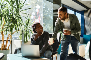A young couple shares a joyful moment in a chic hotel lobby, sipping coffee and enjoying their vacation.