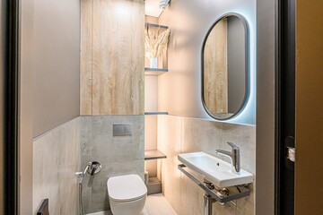interior apartment Modern, compact bathroom with grey tiles, wood accents, and minimalist fixtures....