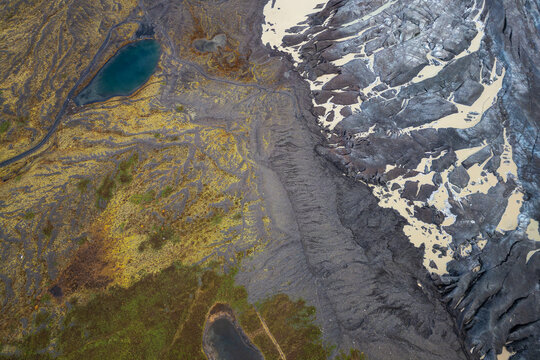 Contrasting textures of glacial ice, earth, and water from above