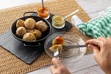 A rustic black dish of papas arrugadas, a traditional Canarian dish, elegantly arranged and...