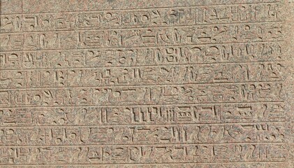 Ancient egyptian hieroglyphs engraved on the wall.
