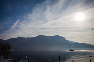 Boat sailing on lake during at November down. Lugano, Ticino, Switzerland