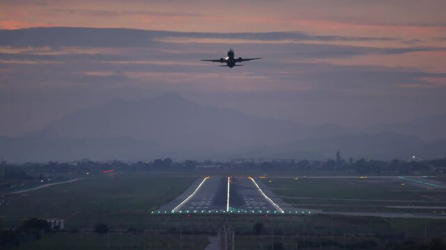 Locked shot of an Aircraft taking off at dusk, Alicante airport, Spain
