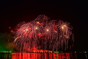 Beautiful fireworks set off in the middle of the sea.