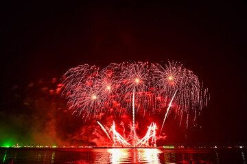 Beautiful fireworks set off in the middle of the sea.