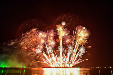 Beautiful fireworks set off in the middle of the sea.