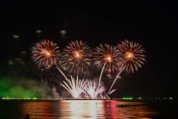 Beautiful fireworks set off in the middle of the sea.