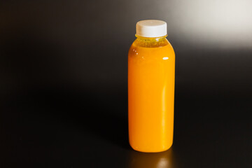 transparent bottle with orange juice