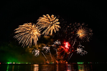 Beautiful fireworks set off in the middle of the sea.