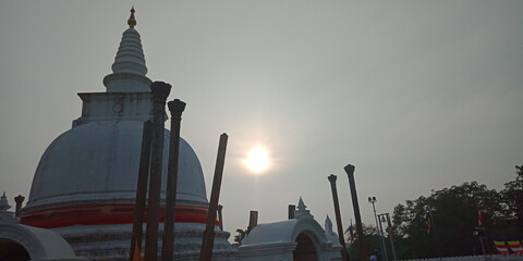 Sacred Thuparama Dagoba in Anuradhapura, Sri Lanka – Ancient Buddhist Stupa under Clear Blue Sky. Thuparamaya Stupa Public Space – Iconic Buddhist Monument in Sri Lanka's Anuradhapura Sacred City, 