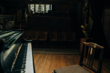 black grand piano at spot light in dark room