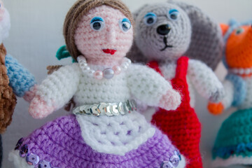 Handmade crocheted woolen toys on a white background.