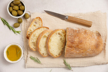 Fresh sliced ciabatta with olive oil on an ancient cutting board