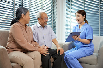 Obraz premium nurse or caregiver meeting and talking with about health with senior couple