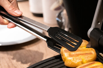 The process of cooking ruddy potatoes on a grill