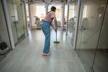 Personnel utilize mops to clean floors, ensuring clean and safe environment for cats. Hygiene, antibacterial dusting in animal accommodation area, consistent floor wash in pet hotel for best service
