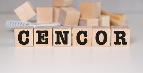 Censor word written on wood block. Censor text on cement table for your desing.