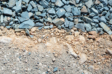 Granite chippings layer texture for road asphalting preparation, close up