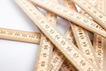 Abstract backdrop with a tangled wooden measuring meter, close up with copy space