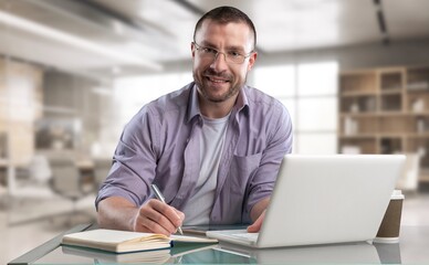 Confident young male professional working in modern office.