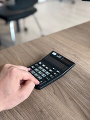 a person doing math on a calculator by hand
