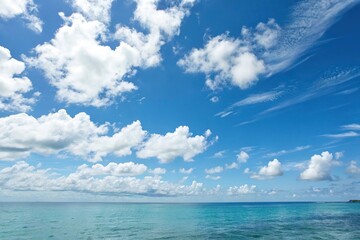 Obraz premium A serene blue sky with soft white clouds drifting lazily across the horizon, natural beauty, calm landscape, serene views