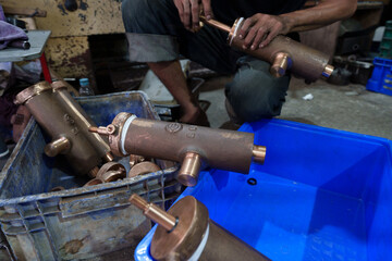 Brass air pump cylinder parts ready for assembly in industrial machinery factory