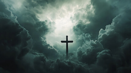 Fototapeta premium Dramatic cross silhouette against dark stormy clouds evokes deep emotions