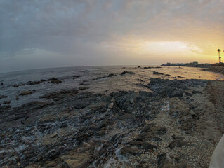 Rocky Beach in Málaga at Sunset with Calm Waves and Soft Sky