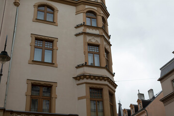 This historic building features stunning windows, elegant architecture, and unique structures, all beautifully set in a charming urban area that attracts visitors and locals alike