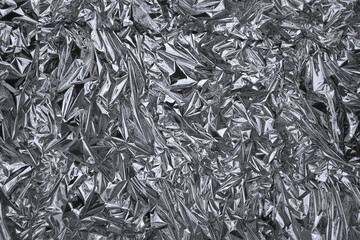 Crumpled silver foil shining texture background
