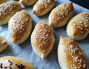 Baked delicious oriental pies with filling, sprinkled with fragrant seeds