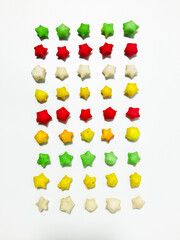 Pilus bintang is a unique Indonesian snack. It has a colorful star shape with a savory and crunchy taste. Served on wooden bowl. Isolated white background