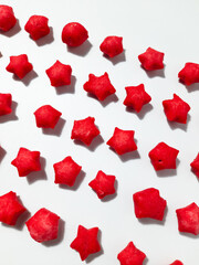 Pilus bintang is a unique Indonesian snack. It has a colorful star shape with a savory and crunchy taste. Served on wooden bowl. Isolated white background