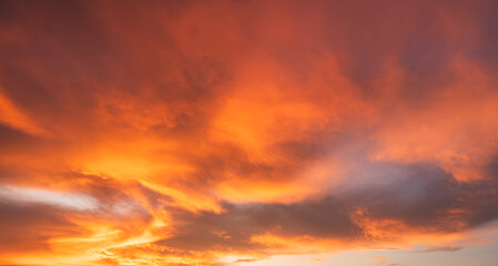 Dramatic orange sunset clouds fluffy in evening sky, Golden hour with Red, Orange, Yellow sunlight background, Fantastic horizon nice Dusk sky after sun down, Nature Background 