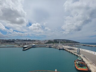 Fototapeta premium Moroco tangier apr 26 2024 Scenic View of Tangier Port and Cityscape Under Cloudy Skies