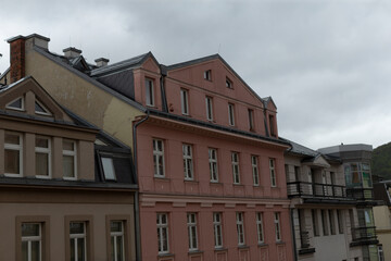 The artistic view showcases Europeanstyle, multistory buildings that stand tall under a blanket of cloudy skies, creating a striking urban landscape filled with modern architectural elements