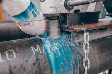 metal drill bit make holes in pipeline on industrial drilling coolant machine.