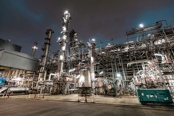 Fototapeta premium Oil refinery heavy plant from industry zone, night view tank oil and gas petrochemica
