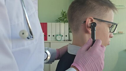 Young boy undergoing an ear examination in a medical office