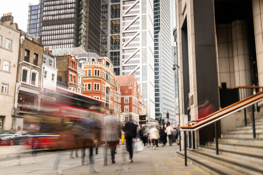London city street scene with financial buildings and motion blurred people - Powered by Adobe