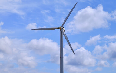 wind turbines generating electricity in power station green energy renewable with blue sky background